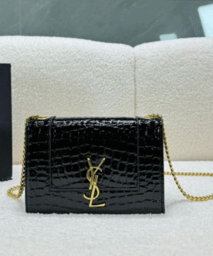 A black, polished leather crossbody bag